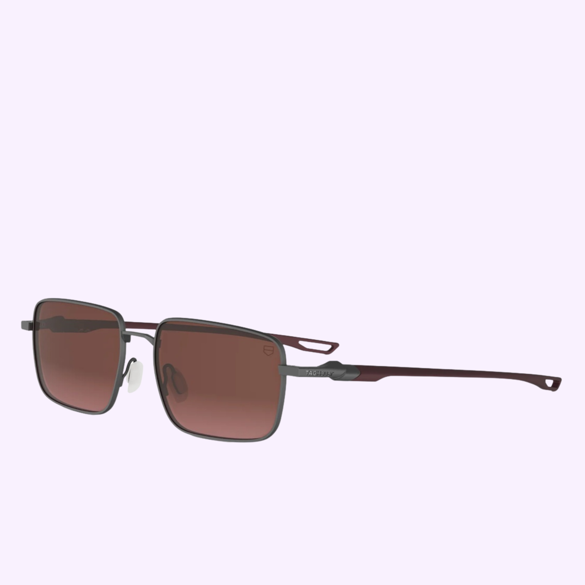 Tag Heuer Optical Sunglasses TH40060U 5612T feature rectangular brown lenses and thin burgundy metal frames, shown on a light purple background—100% authentic from a Miami Authorized Dealer.