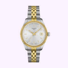 The Tissot Watches Ballade 34mm T1562102203100 features a silver and gold bracelet, silver textured dial, gold markers and hands, fluted bezel, Swiss Quartz movement, and a date window at 3 o’clock—elegant on any light background.