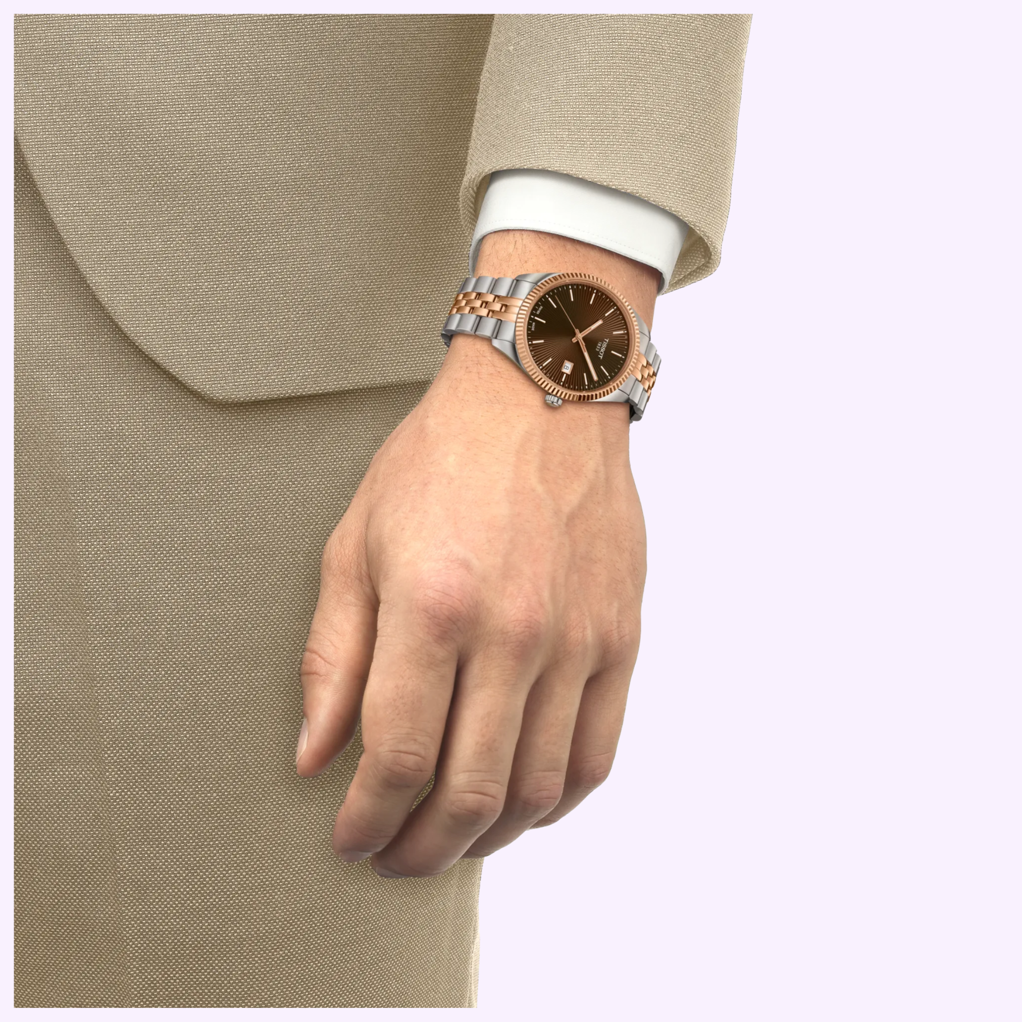 A person in a beige suit reveals a Tissot Watches Ballade 40mm T1564102229101 with a two-tone metal band and brown face, showcasing silver, gold, and rose gold PVD accents and Swiss Quartz movement.