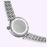 The back of a silver-tone Tissot Watches Desir T1522231149600 watch with a metal link bracelet, showing inscriptions including the brand, model number, and water resistance specifications.