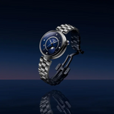 A round Tissot Watches Desir T1522231149600 watch with a deep blue face, diamond-set hour markers, and a moon phase display on a silver-tone metal link bracelet.