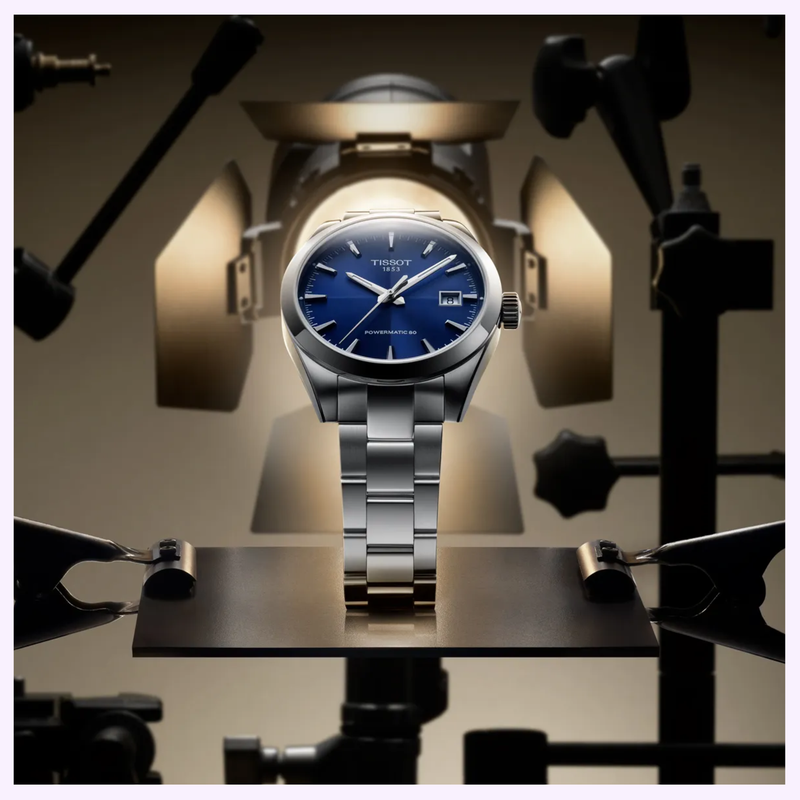 Tissot Gentleman 38mm T1658071104100 Swiss automatic watch with blue dial displayed on a stand under studio lighting