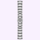 A silver metal watch bracelet bearing a fold-over clasp engraved with TISSOT 1853 is displayed vertically on a light purple background. This refined accessory is crafted for the Tissot Watches PR 100 34mm T1502102103100, exemplifying the brand’s hallmark of timeless sophistication and precision Swiss craftsmanship.