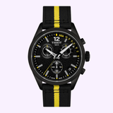 The Tissot Watches PR 100 Tour de France 2026 40mm T1504173705700, crafted by Tissot Watches, is a black chronograph watch adorned with yellow accents, three subdials, a date display, and a black fabric strap featuring a central yellow stripe. Set against a pale lavender background and powered by precise Swiss Quartz movement, this timepiece blends sporty elegance with dependable performance.
