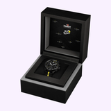 A Tissot Watches PR 100 Tour de France 2026 40mm T1504173705700 chronograph, featuring a sleek black design with yellow accents, is displayed in an open black Tour de France edition box adorned with both the Tissot Watches and Tour de France logos on the inside lid. Crafted with precise Swiss Quartz movement, this standout timepiece from Tissot Watches exemplifies performance and style.