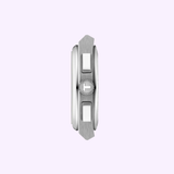 A close-up, top-down view of the silver metal crown flanked by two rectangular push buttons highlights the refined details of the Tissot Watches PRX 41mm T1374171105100 stainless steel watch against a pale purple background.