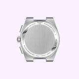 The caseback of the Tissot Watches PRX 41mm T1374171105100 showcases engraved details about its water resistance (10 bar/100m/330ft), sapphire crystal, stainless steel construction, and serial numbers—all beautifully displayed on a light purple background. This fine detail exemplifies the craftsmanship behind this iconic Swiss quartz chronograph by Tissot Watches.
