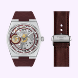 Tissot Watches PRX T1374051737100 Skeleton Damian Lillard Special Edition watch with a silver case, a maroon rubber strap, and gold-toned movement details, shown next to a matching maroon strap with a silver clasp.