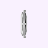 A close-up side view of the Tissot Watches Visodate 39mm T1574071603100 case against a light purple background, highlighting the textured crown and sleek profile of this Swiss automatic timepiece by Tissot Watches.
