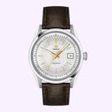 The Tissot Watches Visodate 39mm T1574071603100 by Tissot Watches features a silver dial with gold hands and markers, a Powermatic 80 Swiss automatic movement, date display at 3 o’clock, and a brown leather strap.