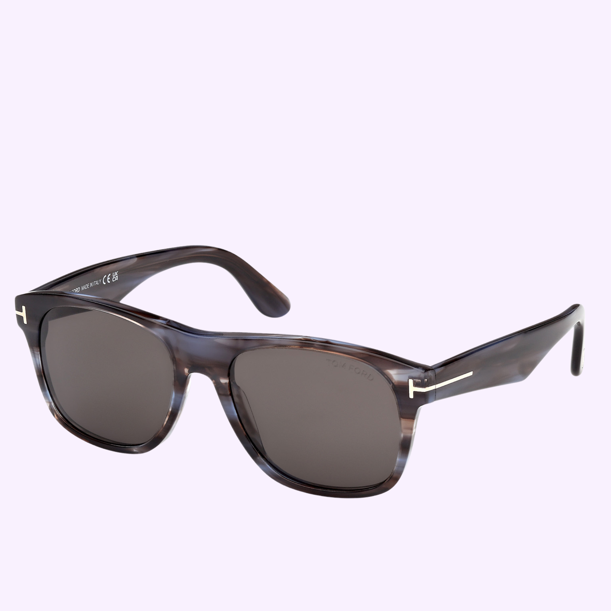 Tom Ford Sunglasses FT1284 5556A—rectangular, dark gray lenses in a translucent marbled frame with metallic temple accents—are shown against a light purple background, offering stylish Miami-inspired flair.