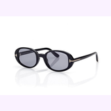Tom Ford Sunglasses FT1364/s 4901A (UPC: 889214643322) in a black oval frame with dark lenses, highlighted by slim gold accents at the hinges. Displayed on a white background with a light purple border—ideal for channeling that effortless Miami style.