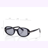 Sleek black oval Tom Ford Sunglasses (model FT1364/s 4901A, UPC 889214643322) with dark lenses are displayed against a white background. Channeling vibrant Miami-inspired style, these sunglasses by Tom Ford feature dimensions of 49 mm lens width, 21 mm bridge, 38 mm lens height, and a temple length of 140 mm.