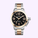 A two-tone metal wristwatch featuring a black dial, oversized crown, and bold numerals, the TW Steel CB405 Unisex Watches Lexor Miami showcases rose gold plated accents on both the bezel and center links of its silver band. The watch also includes a date window and TW Steel Watches branding on the dial, making it an ideal choice for anyone seeking a stylish unisex accessory.