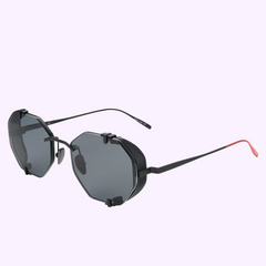 Vysen Sunglasses The Sever SV1 Unisex (UPC: 3423104192186) feature octagonal black frames, dark lenses, thin black arms with mesh side shields, and red temple tips, shown against a pale lavender background.