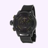 A bold Welder 10000 K31 Chronograph by Welder Watches, featuring a black ion-plated stainless steel case, three subdials, a 100M water resistance marking, and an oversized date display—all set on a black strap for striking contrast against the light background.