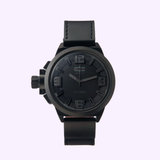 The Welder K22-906 Quartz Men’s Watch by Welder Watches features a bold black dial with an analogue display, large raised numerals, and a thick black leather strap, exemplifying classic masculine style. Photographed on a plain light background, this Lexor Miami edition combines reliability and distinctive design.