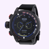 A men’s black rubber strap watch, the Welder K31-2601 by Welder Watches features a round dial with two subdials, vibrant colorful accents, and a striking black strap. The watch face prominently displays “Series K-31” and “Chronograph,” offering a bold aesthetic inspired by the U-Boat K31 Chronograph style—available from Lexor Miami.