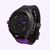 Introducing the Welder K33-9303 50mm Chronograph Men Watch Lexor Miami by Welder Watches—a bold black and purple timepiece crafted from Black Ion-plated Steel, featuring a round analog dial with silver accents and a black rubber strap. Set against a light purple background, this standout chronograph expertly blends precision timekeeping with distinctive style.