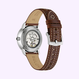 The Bulova Watches Longhorn 96A334 Limited Edition features a brown leather band with visible stitching, a silver case, and a transparent caseback that reveals its automatic movement. Shown from the back to highlight its intricate mechanism.