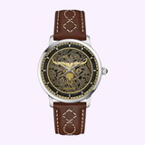 The Bulova Watches Longhorn 96A334 Limited Edition features a brown leather strap with white stitching, a Texas Longhorn skull on the black engraved dial, silver casing, and iconic Bulova Watches branding.