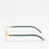 The Cartier Optical CT0052O-010 53 Unisex eyeglasses are shown from the side on a white background, featuring green arms, gold accents, and clear lens frames.
