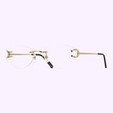 Rimless Cartier Optical Frames CT0487O-001 57 from Cartier Sunglasses feature oval lenses, a gold metal bridge and arms, and black temple tips, evoking a refined sophistication characteristic of luxury eyewear; showcased against a light purple background, they present an elegant alternative to traditional Cartier optical frames.