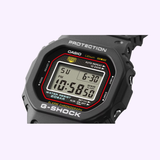Casio G-Shock DW5000R-1A men's digital watch with black bio-based resin band, stainless steel case, 200M water resistance, shock-resistant construction, LED illumination, stopwatch, alarm, and vintage-inspired square design recreated from the original 1983 G-Shock model.