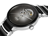 A close-up of the Rado Watches R30012152 Centrix Automatic Open Heart, featuring a black and silver face, visible inner gears, 80-hour power reserve, antimagnetic Nivachron hairspring, and a shiny metal bracelet.