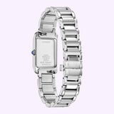 A Citizen Watches Citizen L Bianca EW5620-55A wristwatch in silver is displayed from the back, revealing its sleek metal band and the engraved details on the case back. Set against a light purple background, this elegant women’s luxury watch by Citizen Watches stands out beautifully.