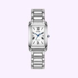 A Citizen Watches Citizen L Bianca EW5620-55A wristwatch by Citizen Watches, featuring a sleek silver metal link band, a rectangular white dial with Roman numerals, and showcased against a light purple background. This elegant women’s luxury timepiece highlights Eco-Drive technology for effortless sophistication and sustainable style.