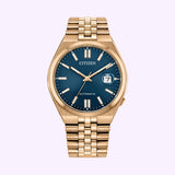 Introducing the Citizen Watches TSUYOSA 60 NK0023-57L, a gold-toned wristwatch by Citizen Watches featuring a bold blue sunray dial accented with gold hour markers and a date window at 3 o’clock. This automatic timepiece comes with an elegant metal link bracelet and is distinctly marked AUTOMATIC on the dial.