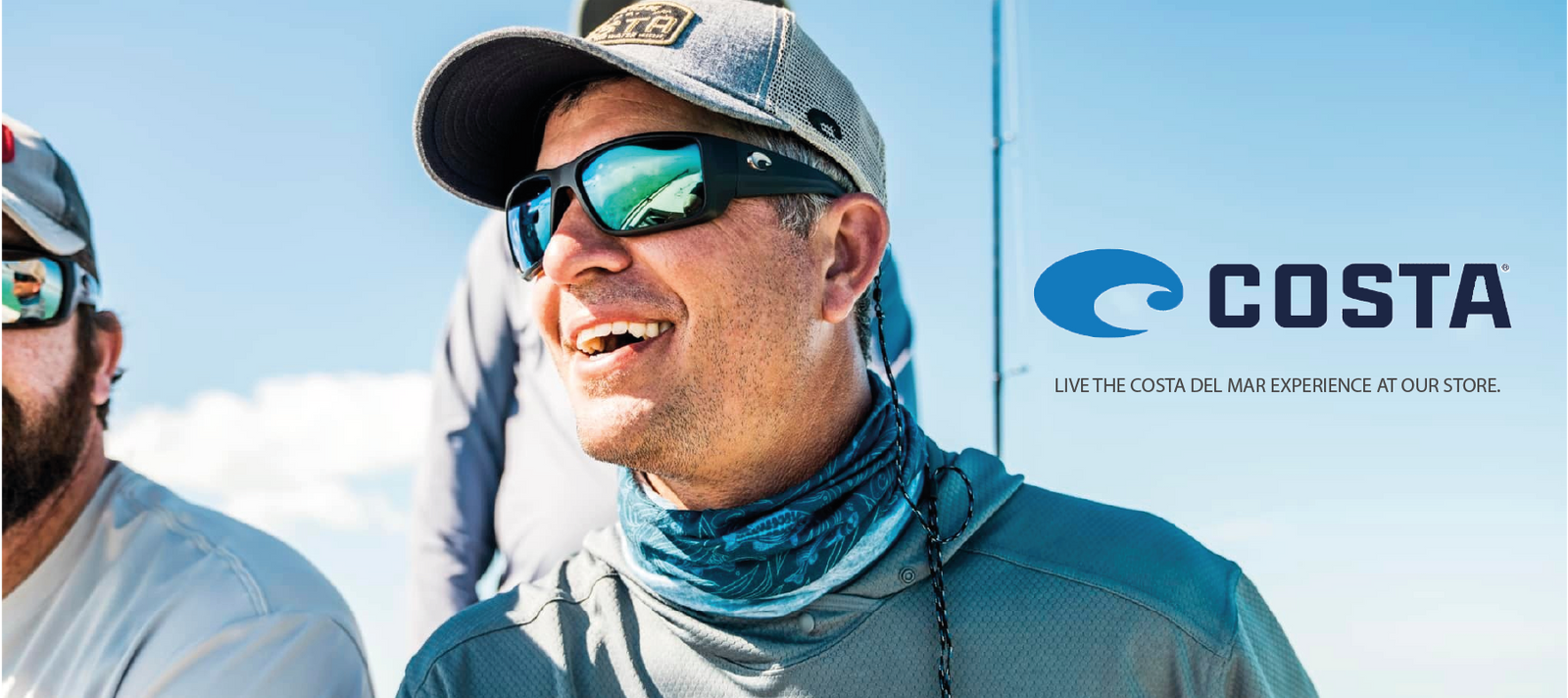 A man wearing sunglasses, a hat, and a blue neck gaiter smiles outdoors in sunny weather. Next to him is the Costa logo and the text Live the Costa Del Mar experience at our store.
