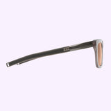 A side view of the Dita Sunglasses DLS429-A-01 LSA-429 by Dita Sunglasses features gray arms with a transparent peach accent near the hinge, set against a light purple background, capturing subtle elegance inspired by Japanese craftsmanship.