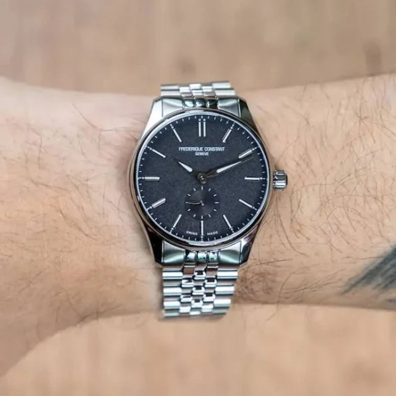 Frederique Constant FC-530G3B6B worn on the wrist, showing the black textured dial and stainless steel bracelet at an angle