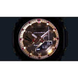 Close-up of the CASIO G-SHOCK ANALOG-DIGITAL GBM2100RH-1A (889232379517) watch face by G-Shock Watches, featuring gold-tone accents, analog hands, a digital display, illuminated hour markers, and showcasing Tough Solar technology as well as unique Rui Hachimura Signature design elements alongside multiple settings and functions.