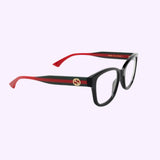 Gucci Optical Frames GG1863O-001 51 by Gucci Sunglasses showcase black rectangular frames with iconic red and green striped arms, a gold circular logo on the side, and distinctive red-tipped temple tips, set against a light purple background.
