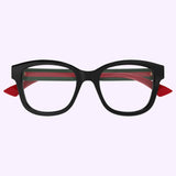 Gucci Optical Frames GG1863O-001 51 by Gucci Sunglasses feature black-rimmed, oval lenses with green and red arms and signature red triangular accents on the sides, displayed against a light purple background—a striking example of Italian luxury designer eyewear.