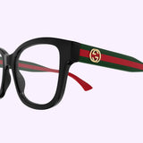 Close-up of Gucci Optical Frames GG1863O-001 51 in black, showcasing green and red striped arms and a gold Gucci logo on the temples, set against a light lavender background.