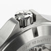 Close-up of a silver crown with star emblem on the brushed stainless steel case of the Hamilton Watches Khaki Field King Day-Date 40mm H64475140, engraved text visible, evoking Miami sophistication.