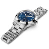 The Hamilton Watches Khaki Field King Day-Date 40mm H64475140 features a stainless steel case, blue dial with white numerals, day-date display, and a metal link bracelet—photographed at an angle on a white background.