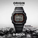 A CASIO G-Shock Watch DIGITAL DW5000R-1A by G-Shock Watches sits atop scattered black rocks, displaying 10:58:50. Text reads “ORIGIN,” “Re-creation of DW-5000,” “40th Anniversary,” and “Absolute Toughness.”.available at lexor miami