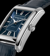 A close-up of the Frederique Constant Classic Carre Automatic FC-303N4C26 shows its rectangular silver case, blue dial with silver hour markers, date window at 6 o'clock, and textured blue leather strap. The grooved crown stands out on the side.