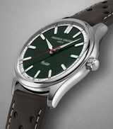 The Frederique Constant Vintage Rally Healey Automatic FC-301HGRS5B26 features a racing green dial, white hour markers, a red seconds hand, polished silver case, and brown leather strap with white stitching.
