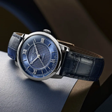 The Frederique Constant Classics Premiere FC-301N3B6 wristwatch features a blue textured dial, silver Roman numerals, and a blue alligator leather strap, highlighting the elegant design of this luxury timepiece.