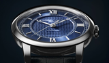 A close-up of the Frederique Constant Watches Classics Premiere FC-301N3B6 shows its blue textured dial, silver Roman numerals and hands, in a polished case with a dark leather strap.