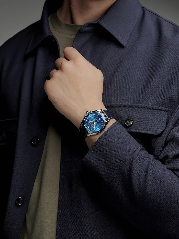 Person wearing the Frederique Constant Runabout Automatic FC-303RMLN5B6 on the wrist with a blue jacket
