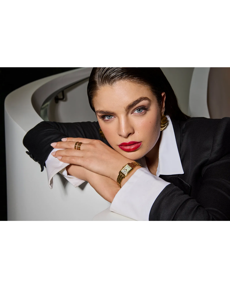 Woman wearing the Bulova Sutton 97L177 watch with a black blazer and gold jewelry