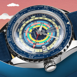 A close-up of the Mido Watch SPECIAL EDITION OCEAN STAR DECOMPRESSION WORLDTIMER M026.829.17.041.00 shows a vibrant analog face with GMT world time zones, blue accents, textured blue band, and stylized cloud background. Includes 1 extra strap. Brand: Mido Watches.