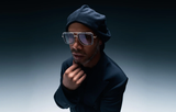 A man in a dark beret, dark jacket, and Dita Sunglasses DUBSIGNAL DTS465-A-03 (UPC 0810121956724) poses with his hand on his chin against a gradient background, capturing the cool unisex style of Dita Sunglasses.